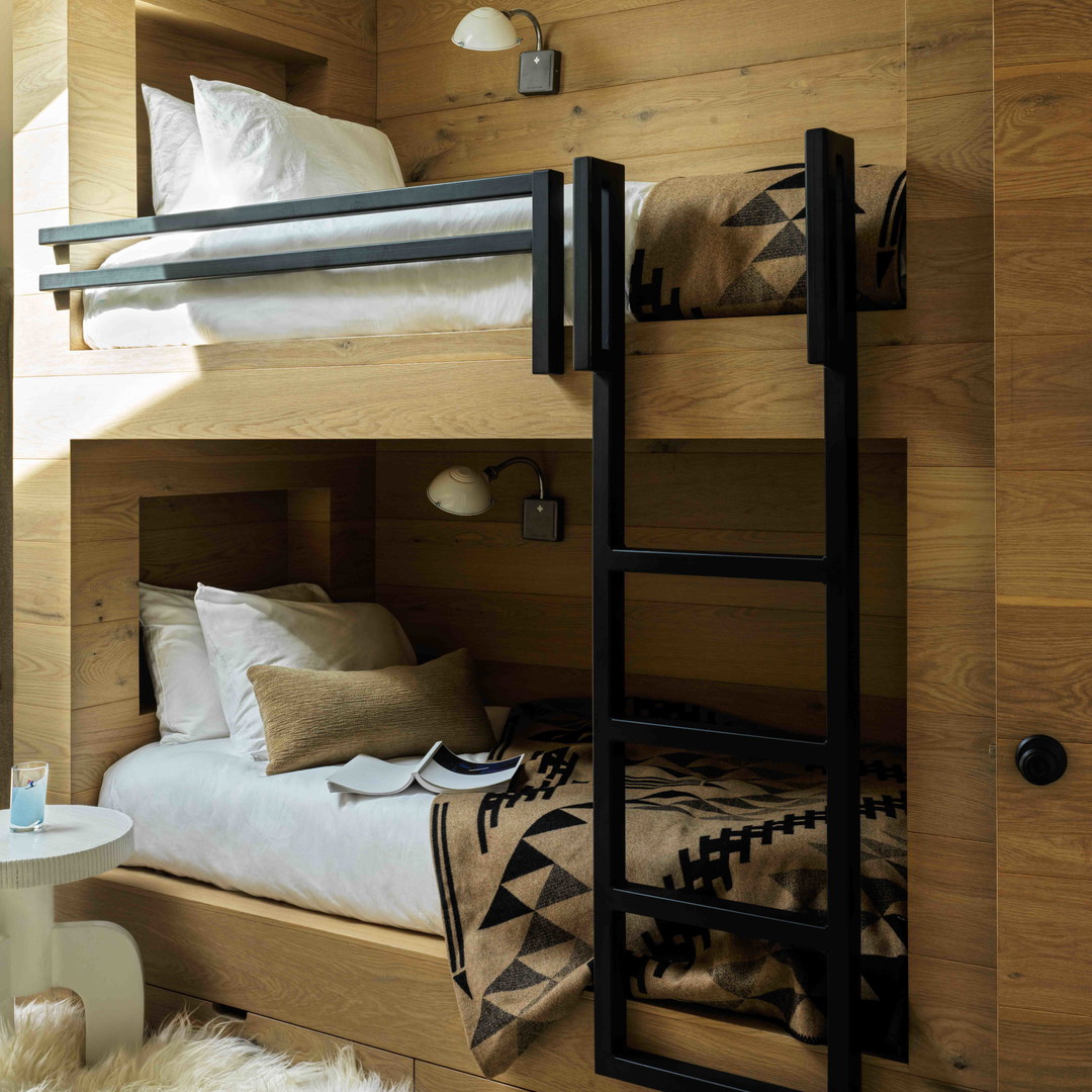 a bunk bed in a room with wooden walls