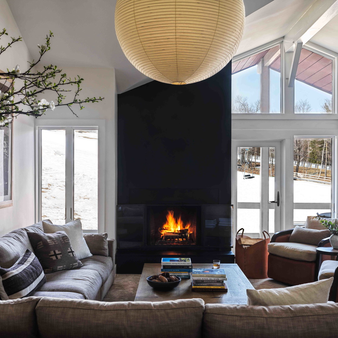 a living room filled with furniture and a fire place