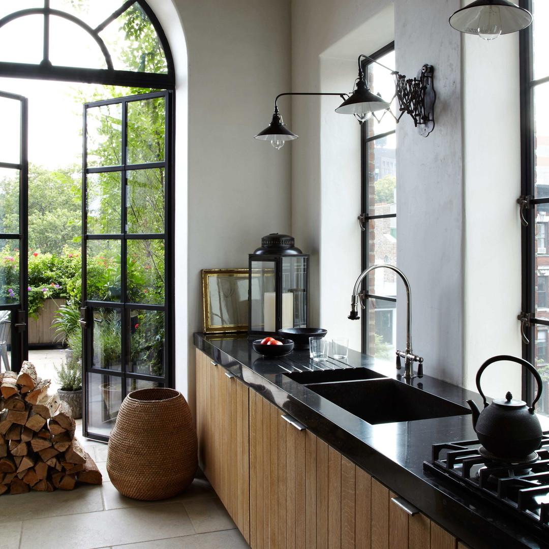 a kitchen with a stove top oven sitting next to a window