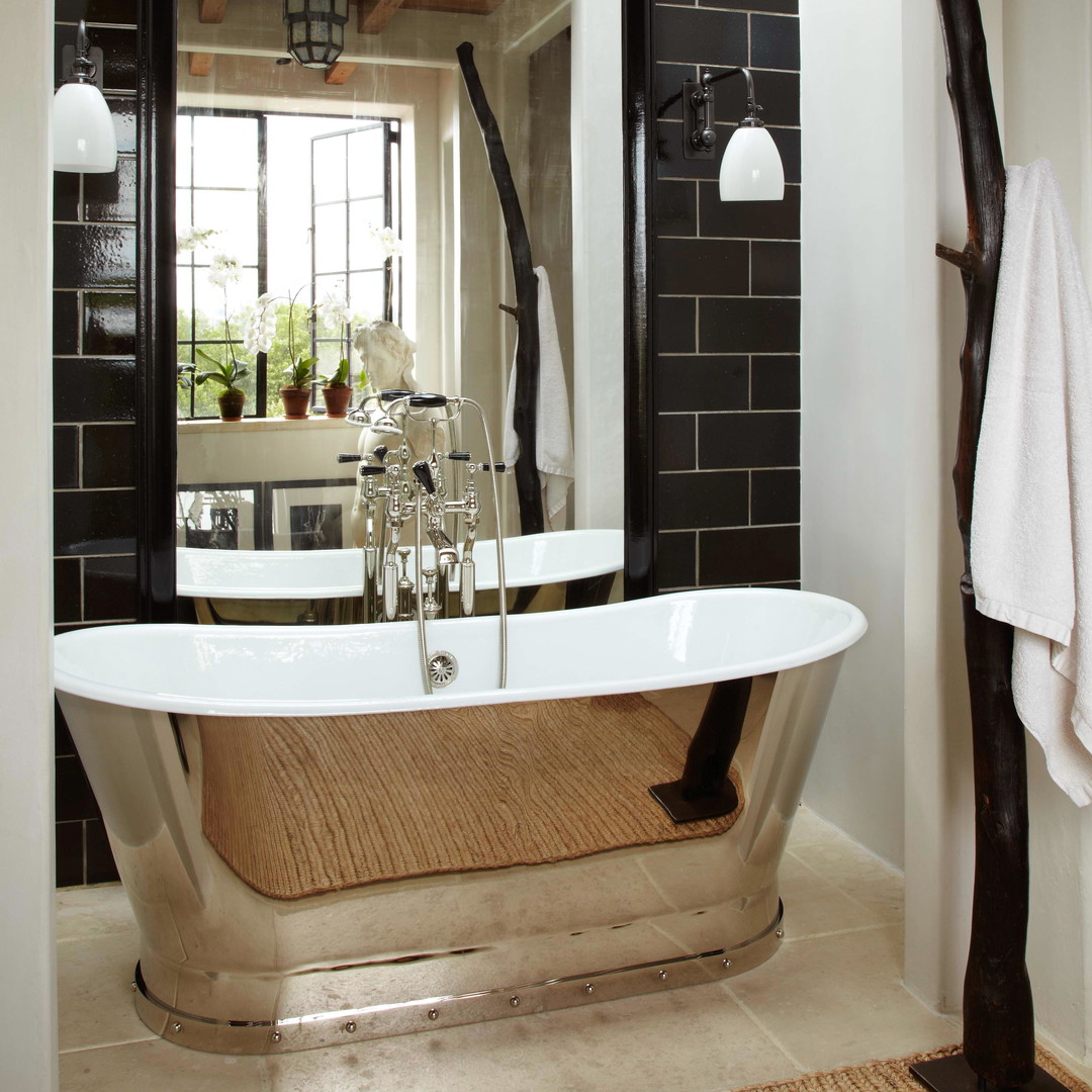 a bathroom with a claw foot tub and a large mirror