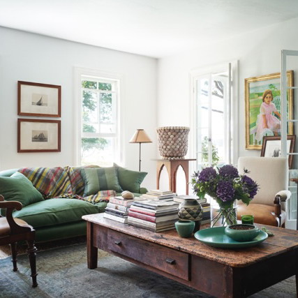 a living room filled with furniture and lots of windows