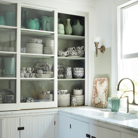 a kitchen filled with lots of white cupboards