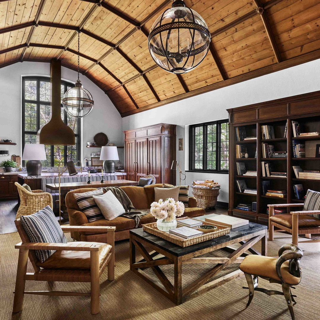 a living room filled with furniture and a wooden ceiling