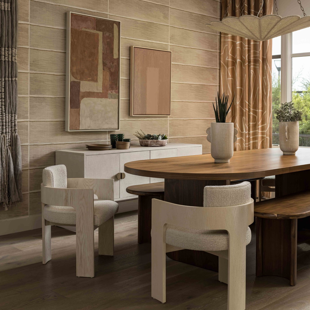 a dining room with a wooden table and chairs