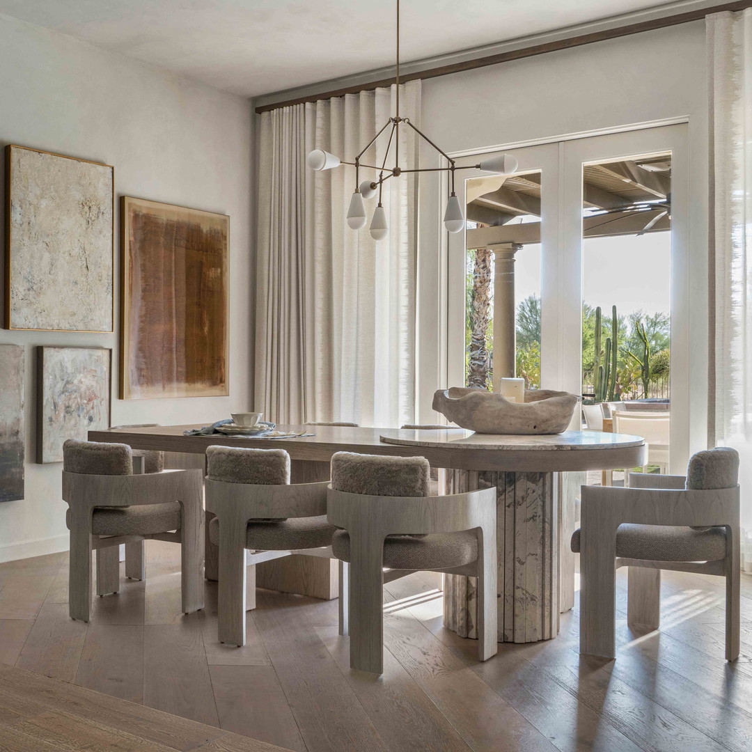 a dining room with a table and chairs