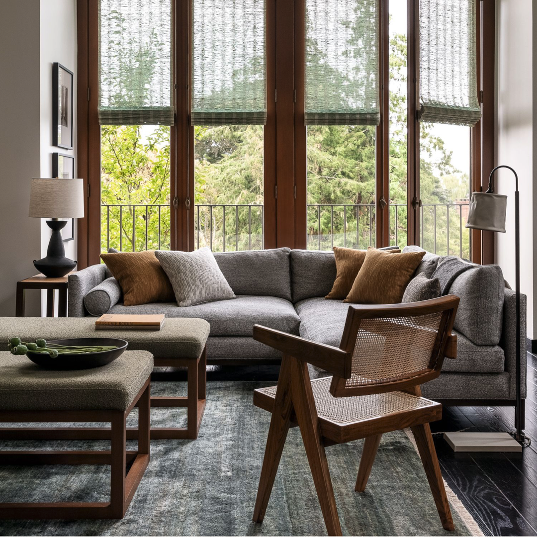 a living room filled with furniture and large windows