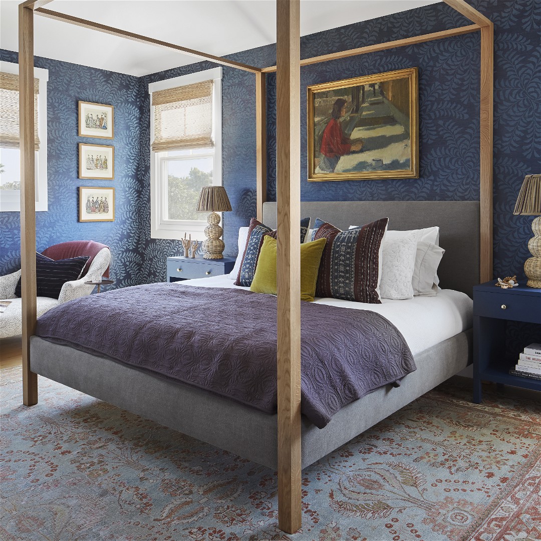 a bedroom with blue walls and a canopy bed