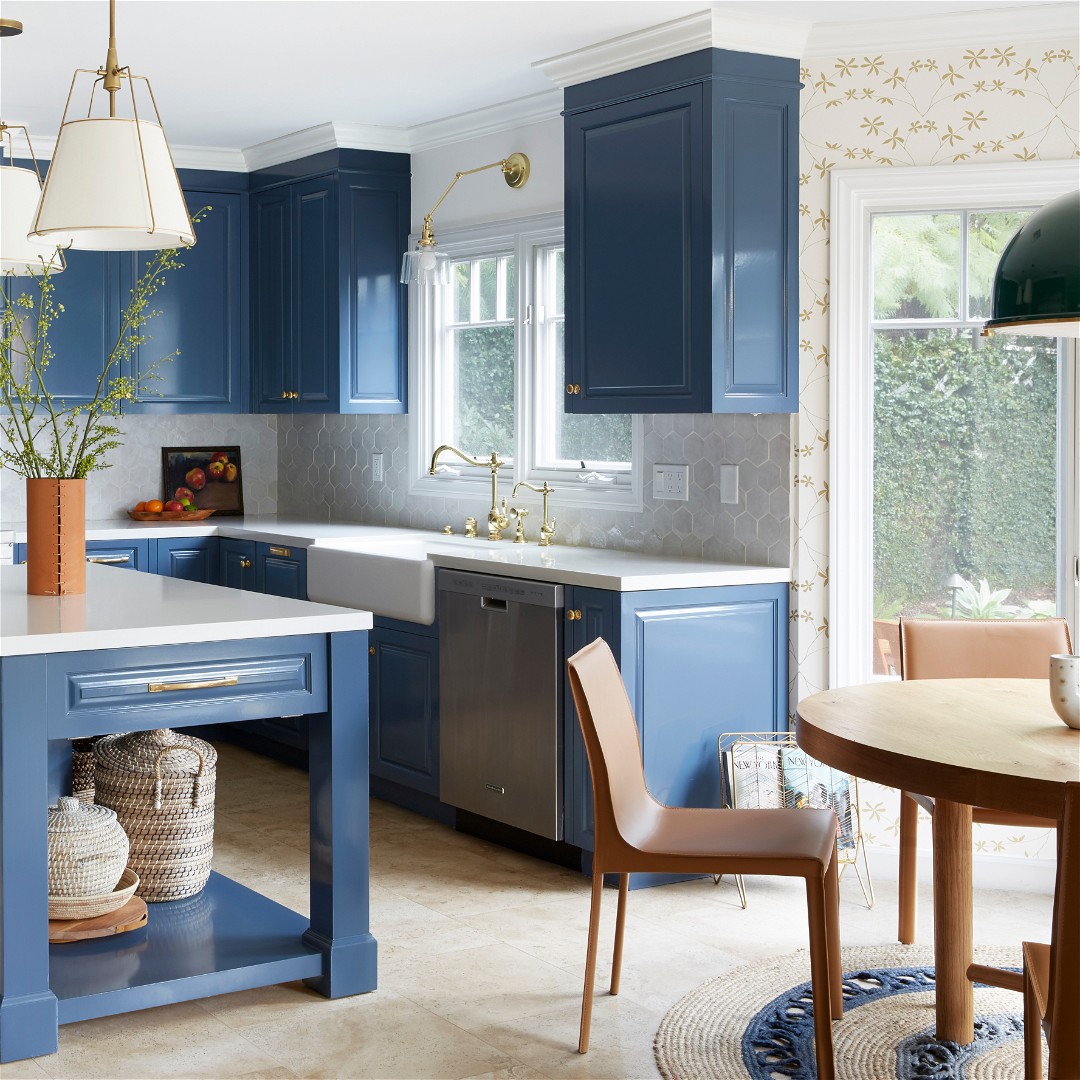 a kitchen with blue cabinets and white counter tops