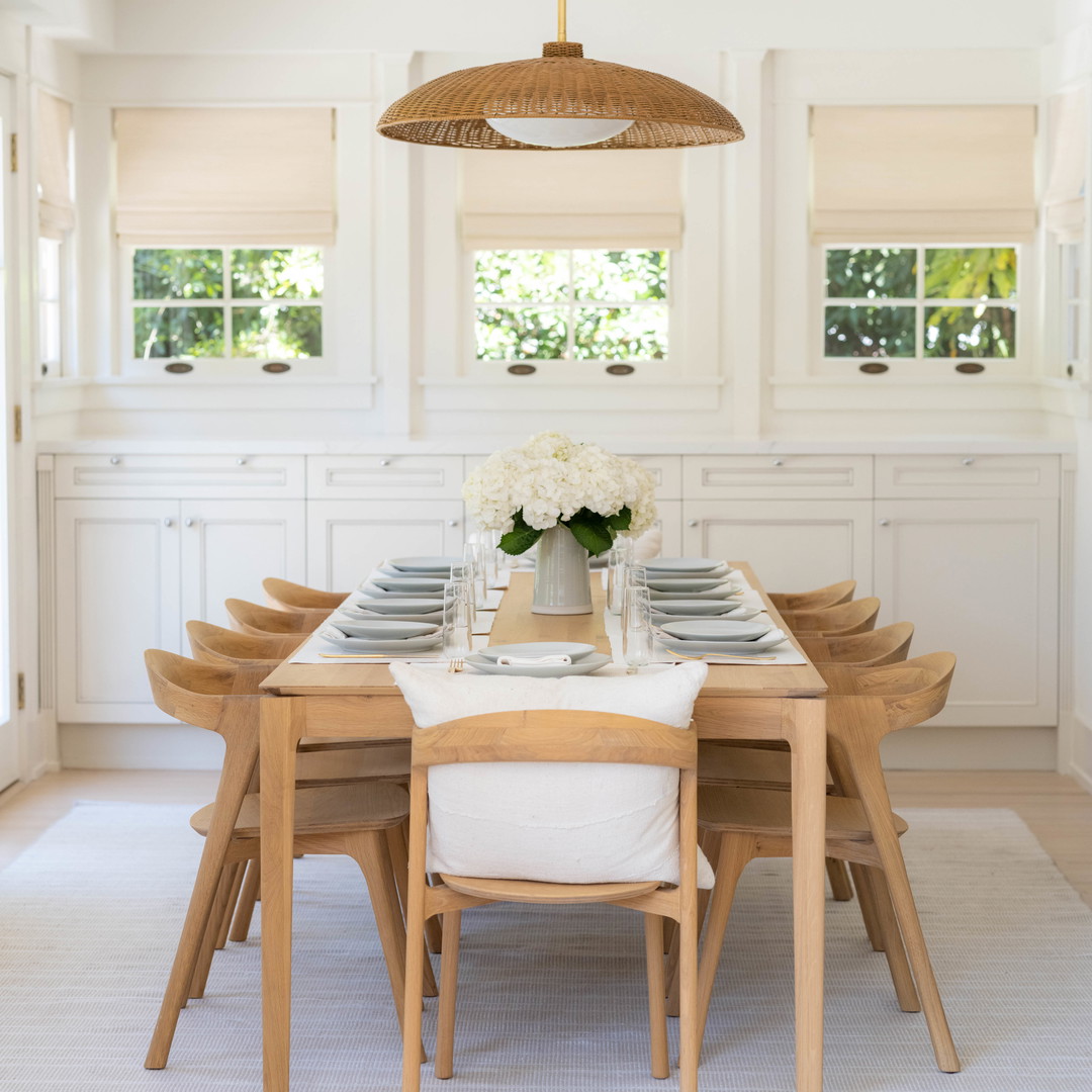 a dining room table with a vase of flowers on it