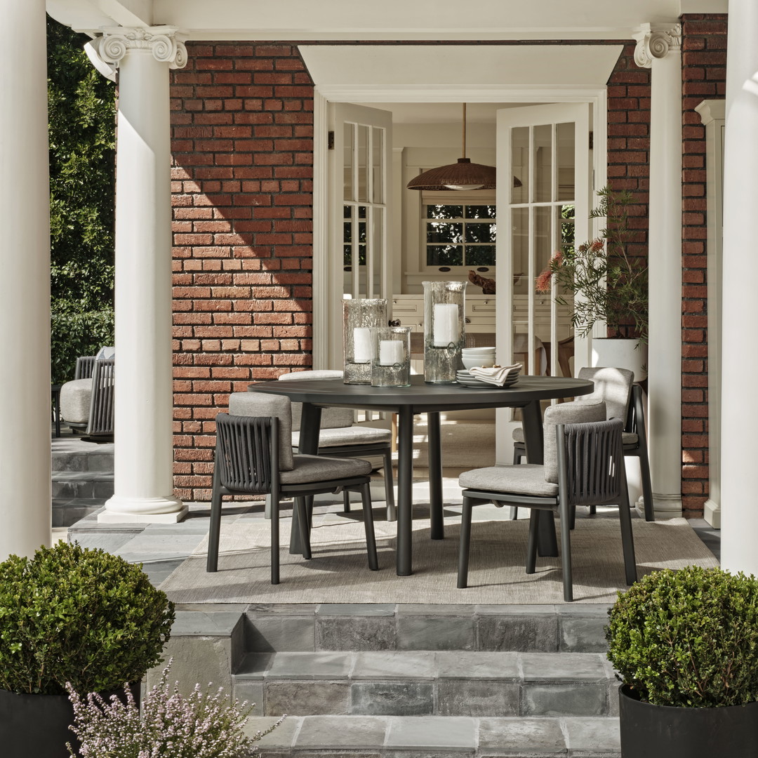 a patio with a table and chairs on it