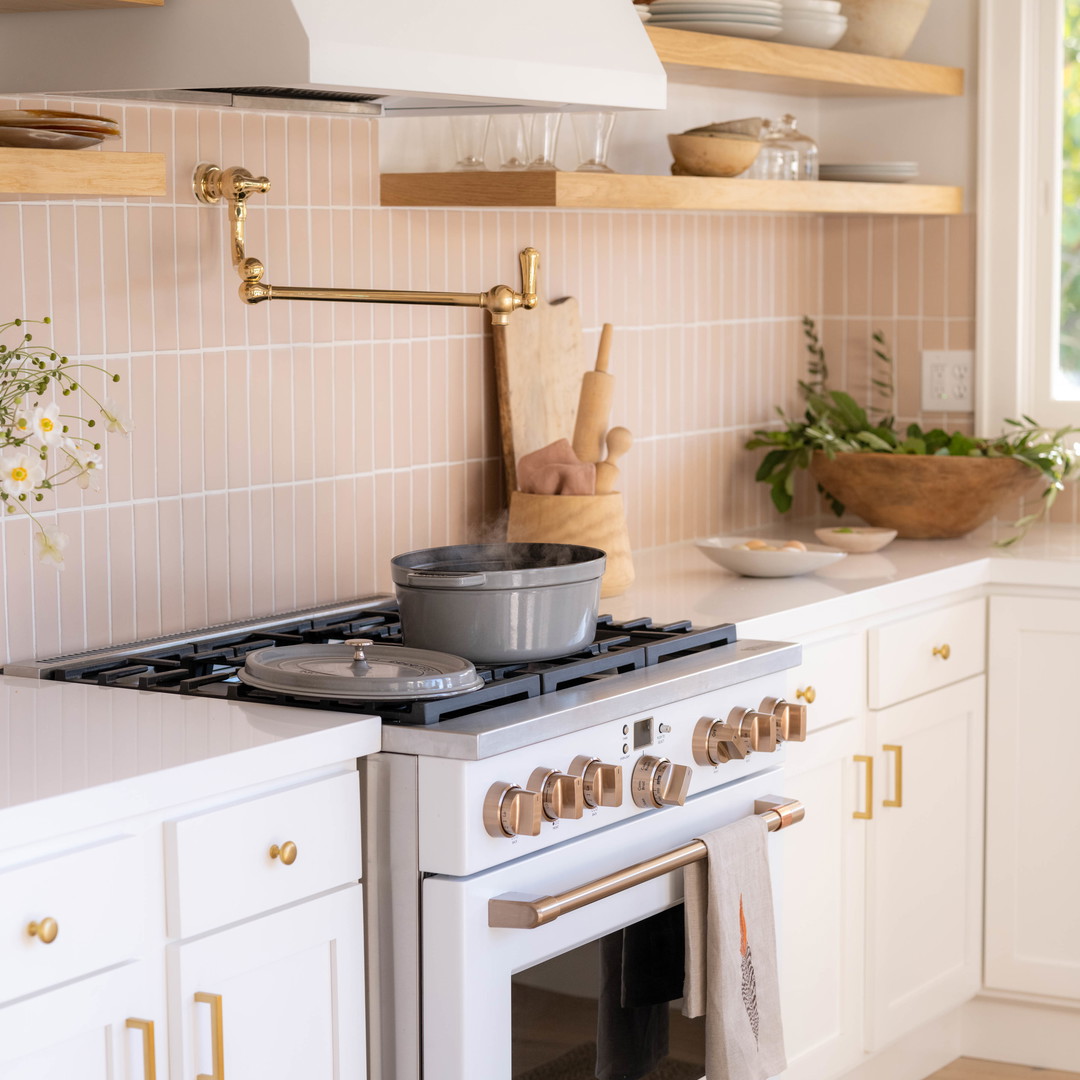 a white stove top oven sitting inside of a kitchen