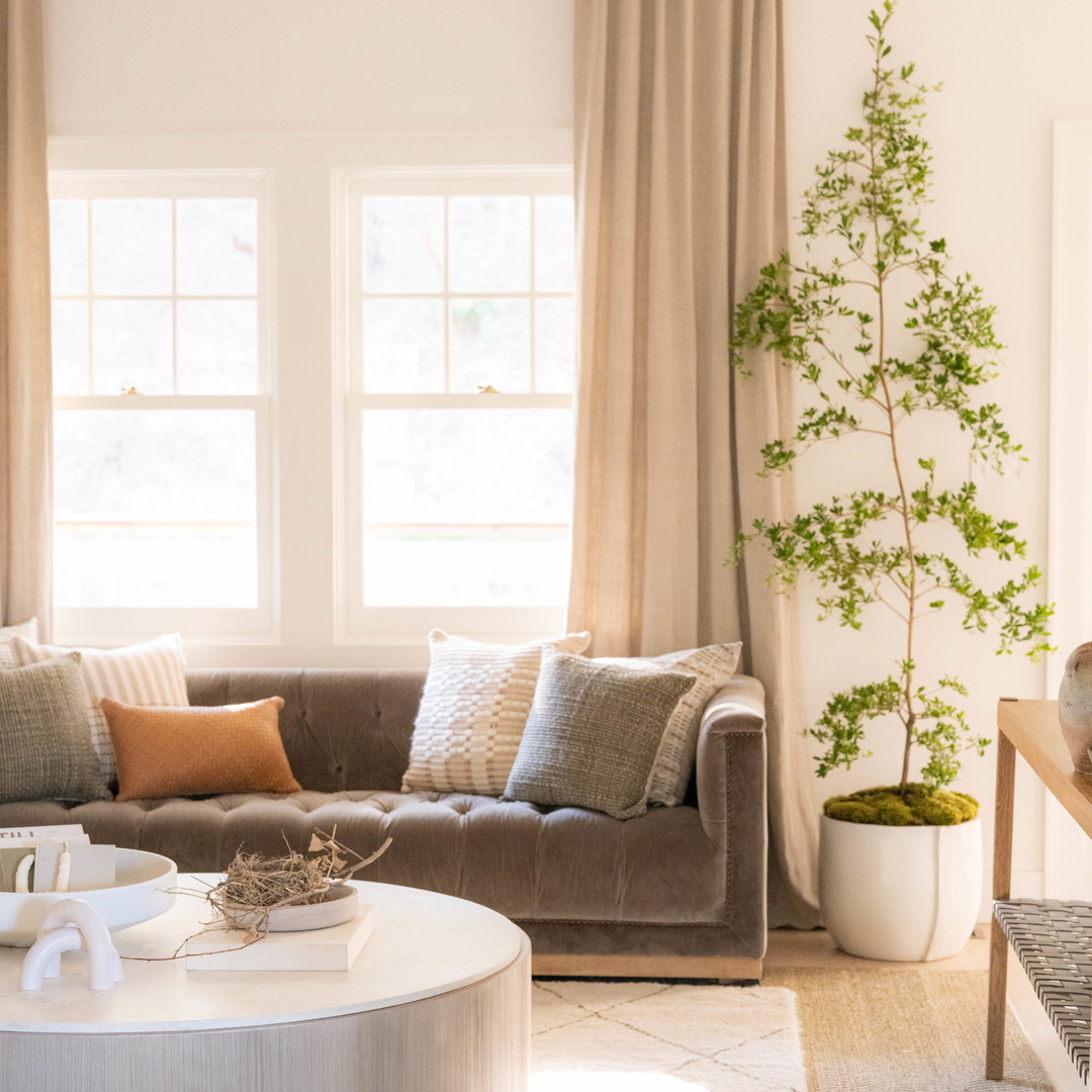 a living room filled with furniture and a large window