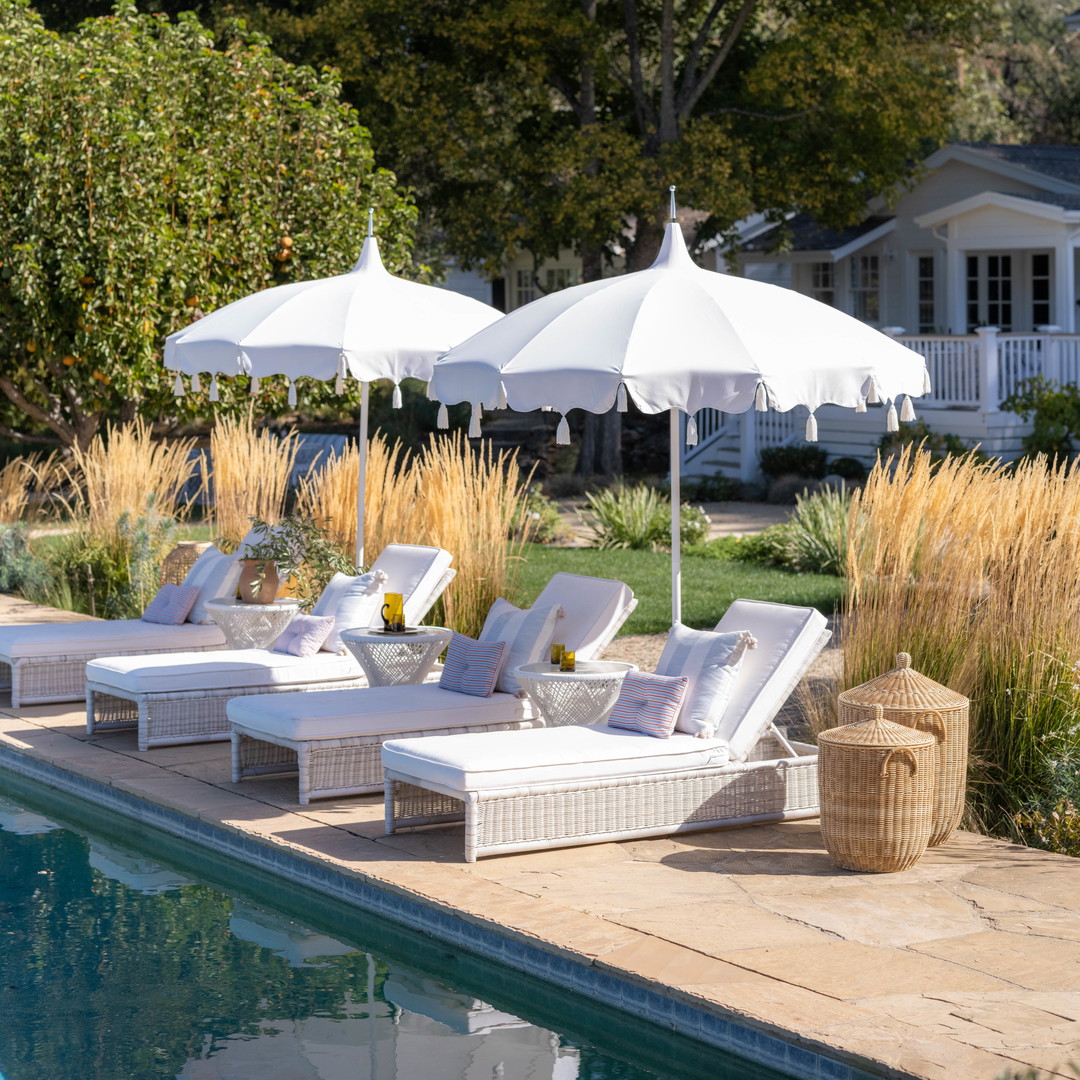 a couple of lounge chairs sitting next to a swimming pool