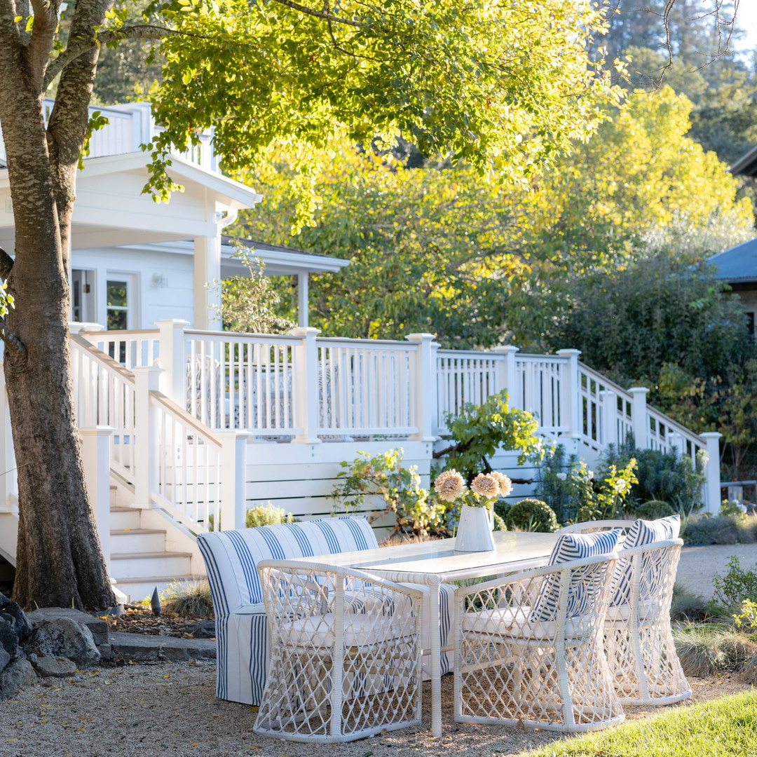 a white table and chairs under a tree