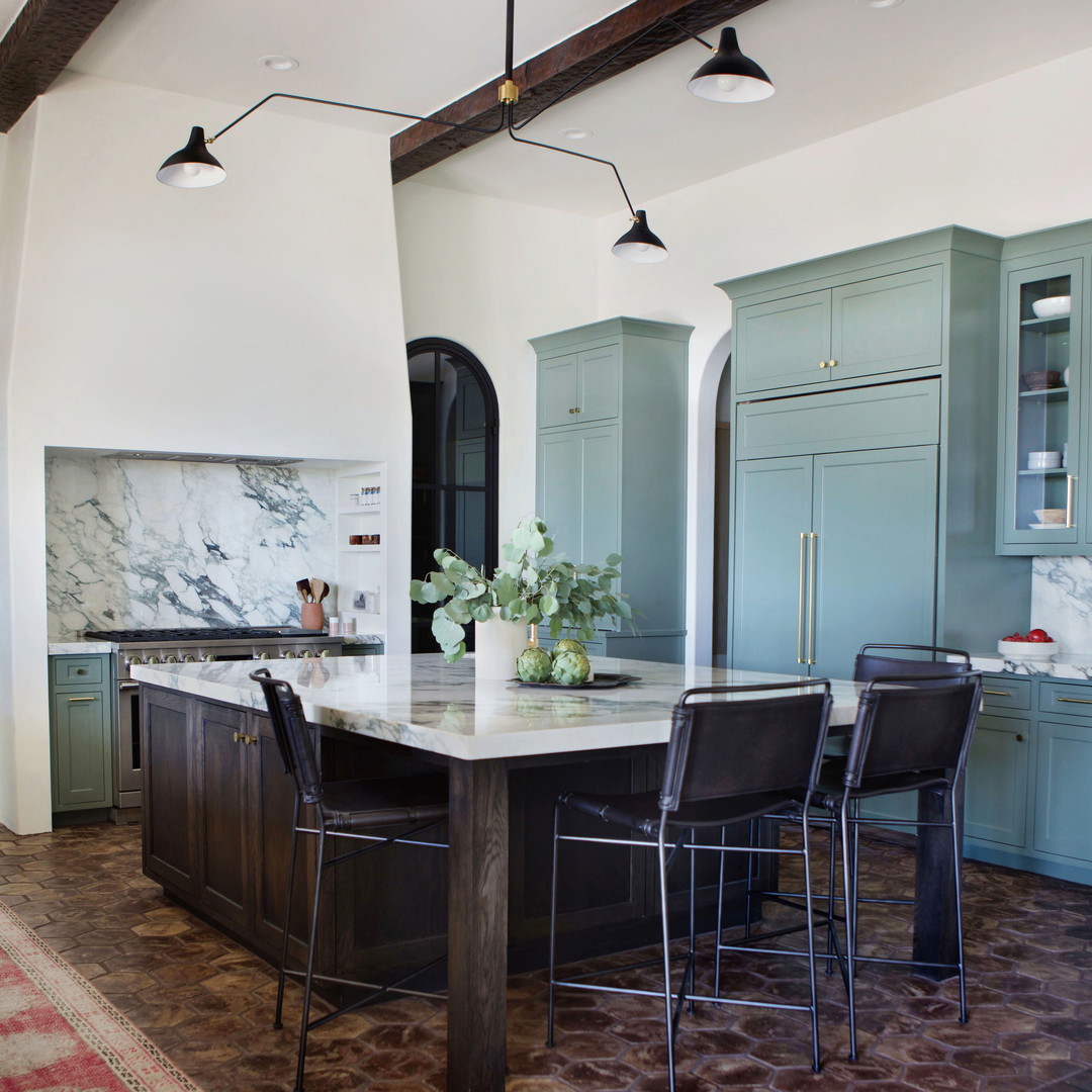 a large kitchen with a center island in the middle of the room