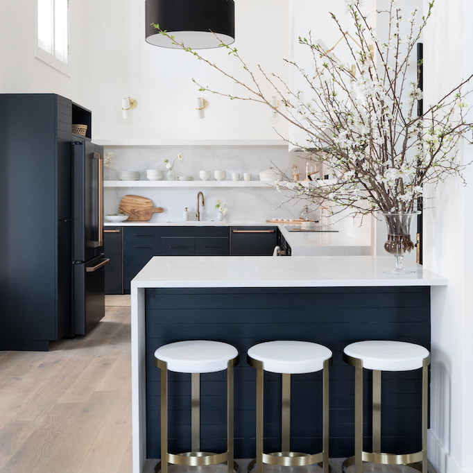 a kitchen with a center island and three stools