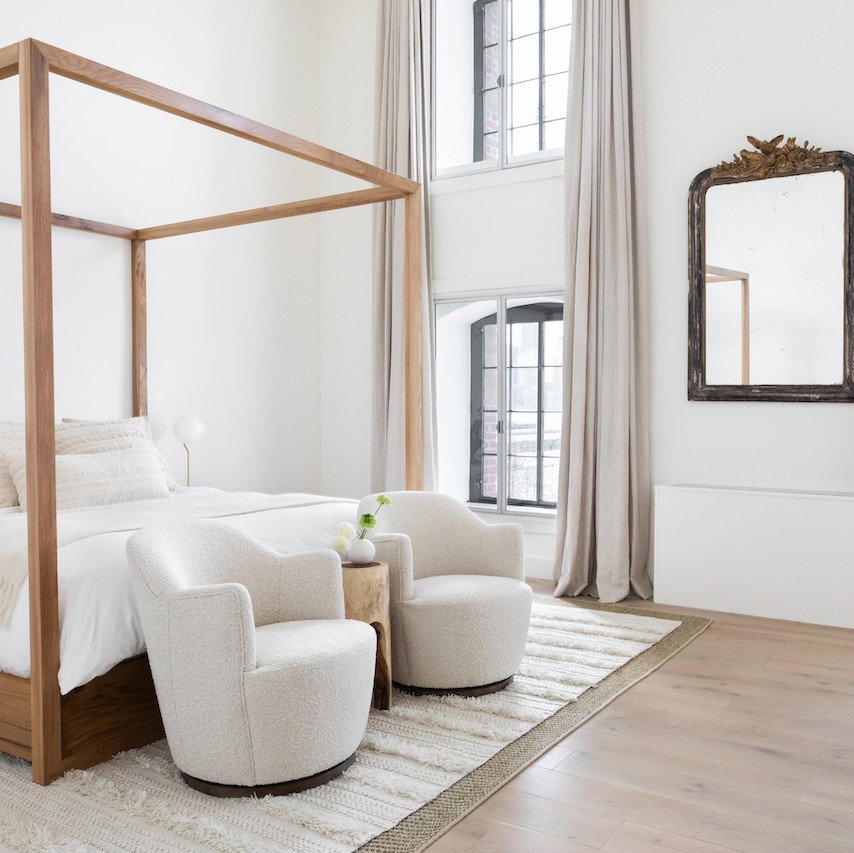 a white bedroom with a four poster bed