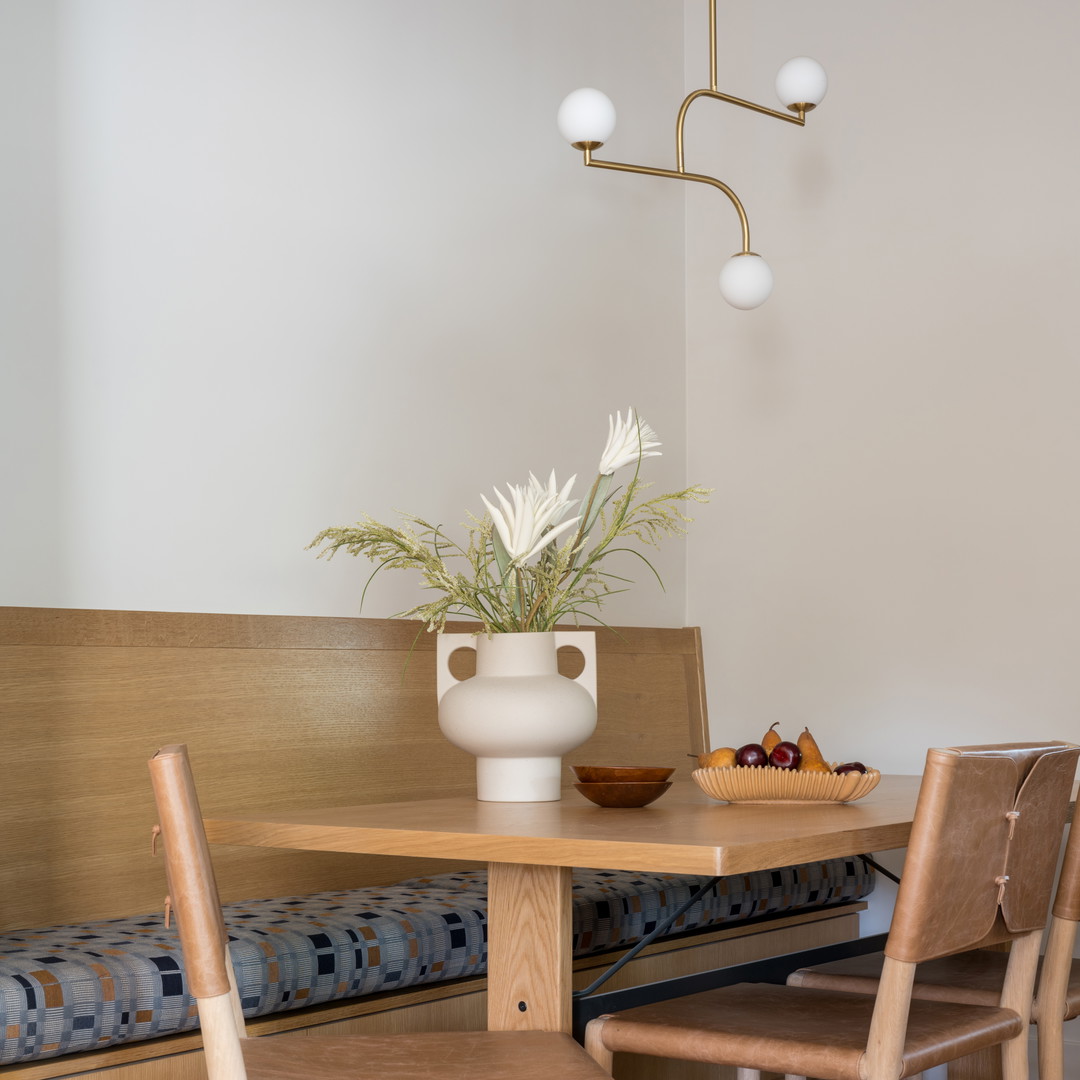 a dining room with a table and chairs and a bench