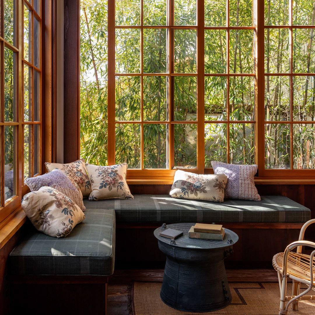 a living room filled with furniture and lots of windows