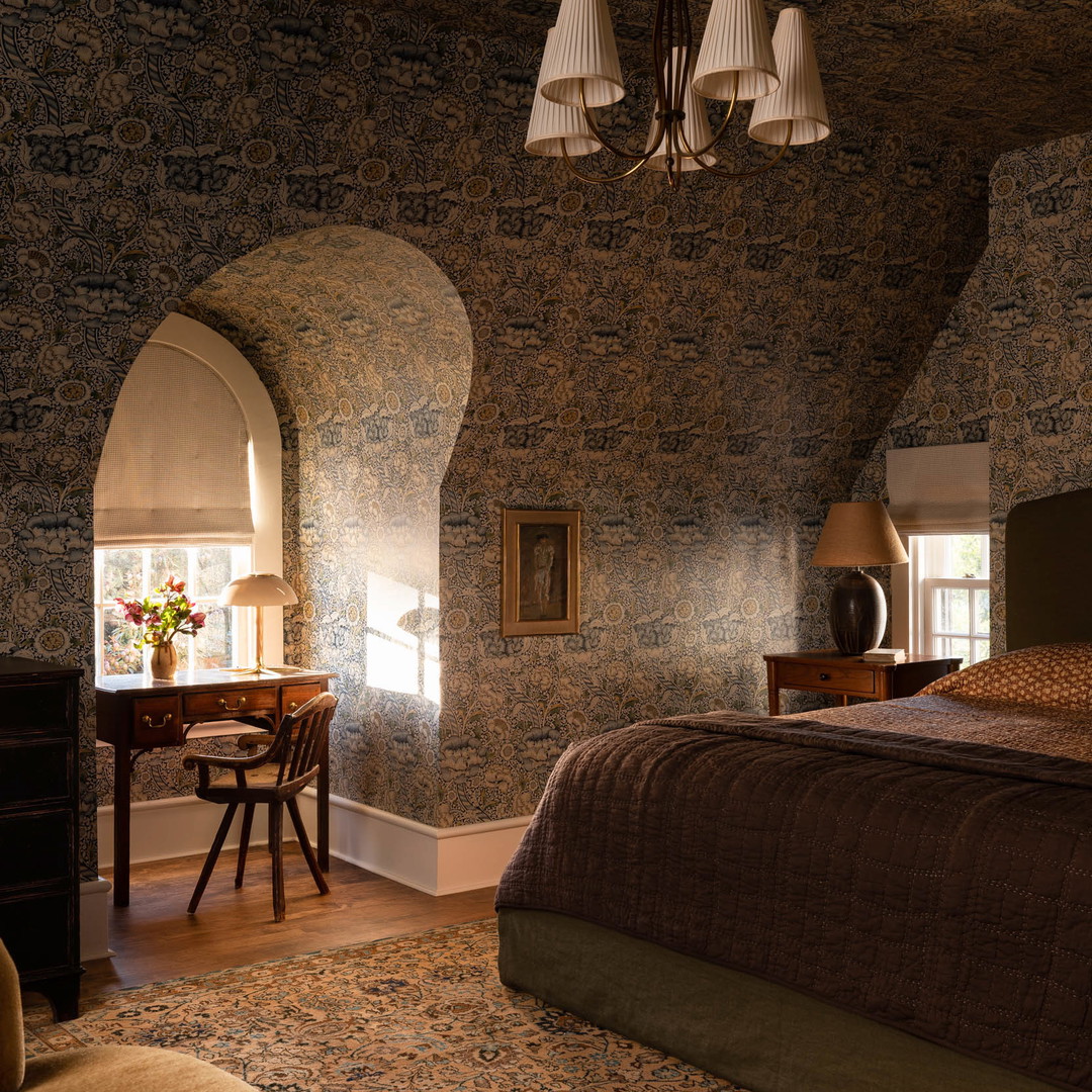 a bedroom with a large bed and a chandelier