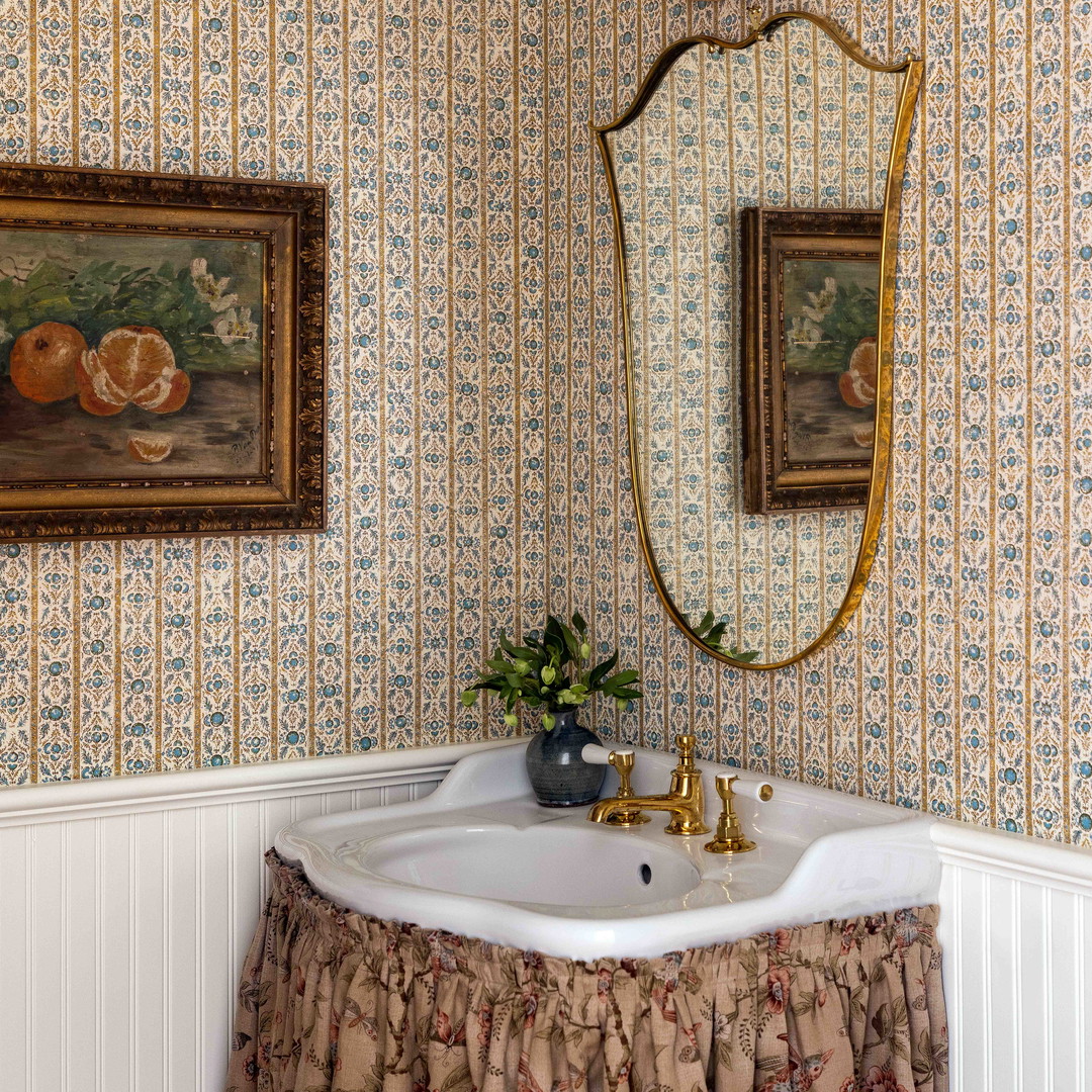 a white sink sitting under a mirror in a bathroom