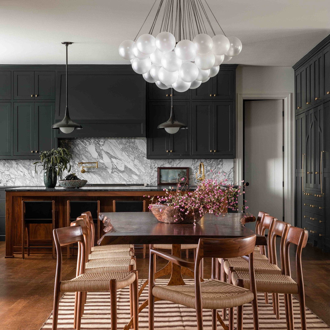 a dining room table with chairs and a chandelier