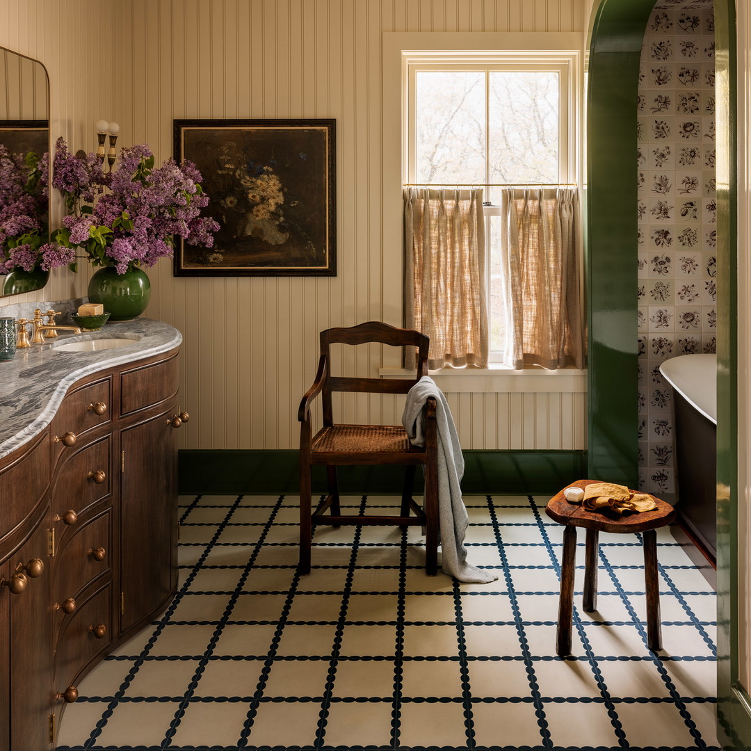 a bathroom with a sink, a chair and a window