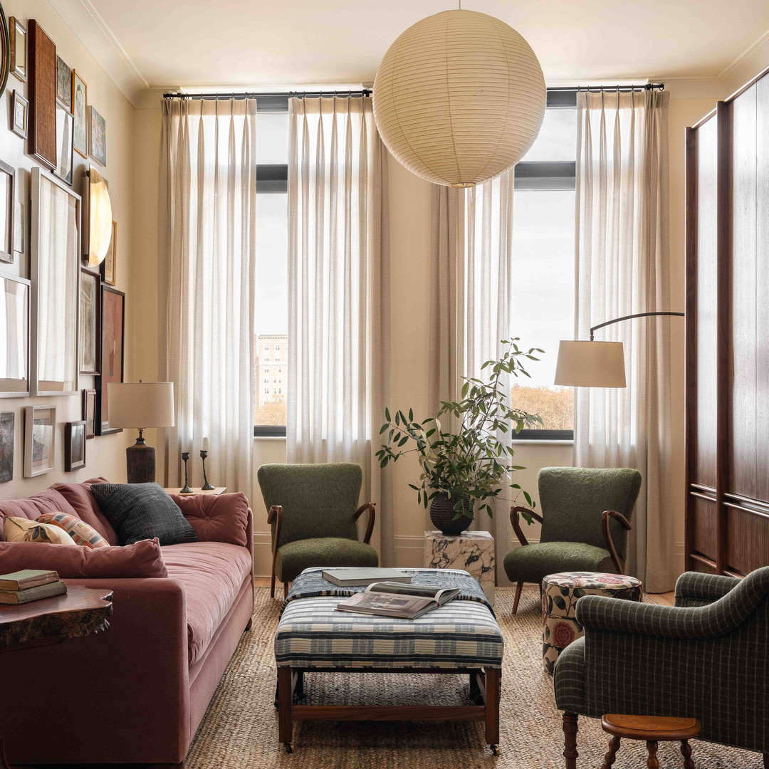 a living room filled with furniture and a large window