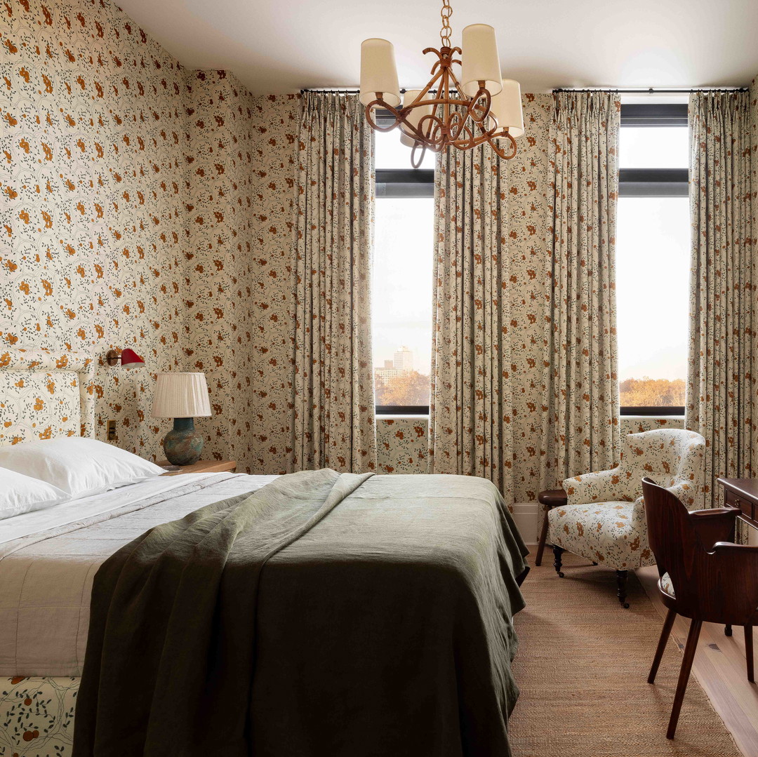 a bedroom with a large bed and a chandelier