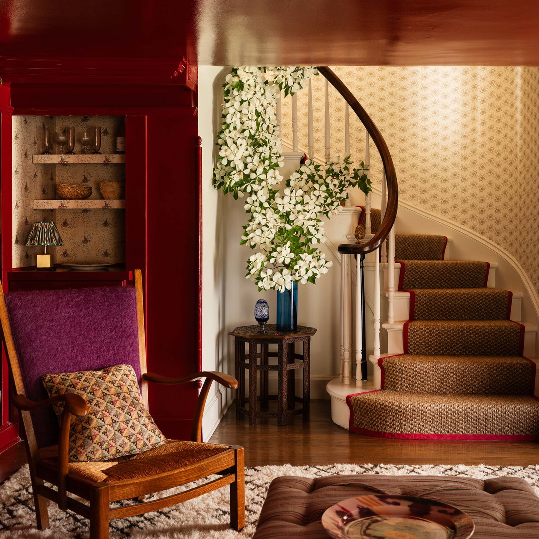 a living room filled with furniture and a spiral staircase