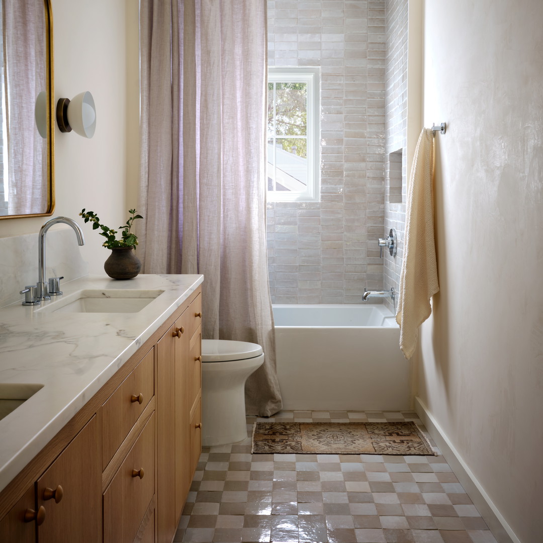 a bath room with a toilet a sink and a bath tub