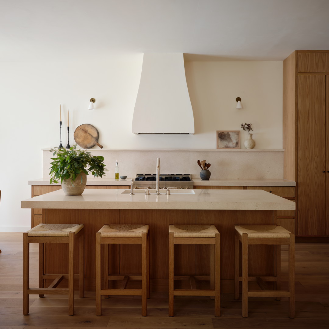 a kitchen with a center island with stools