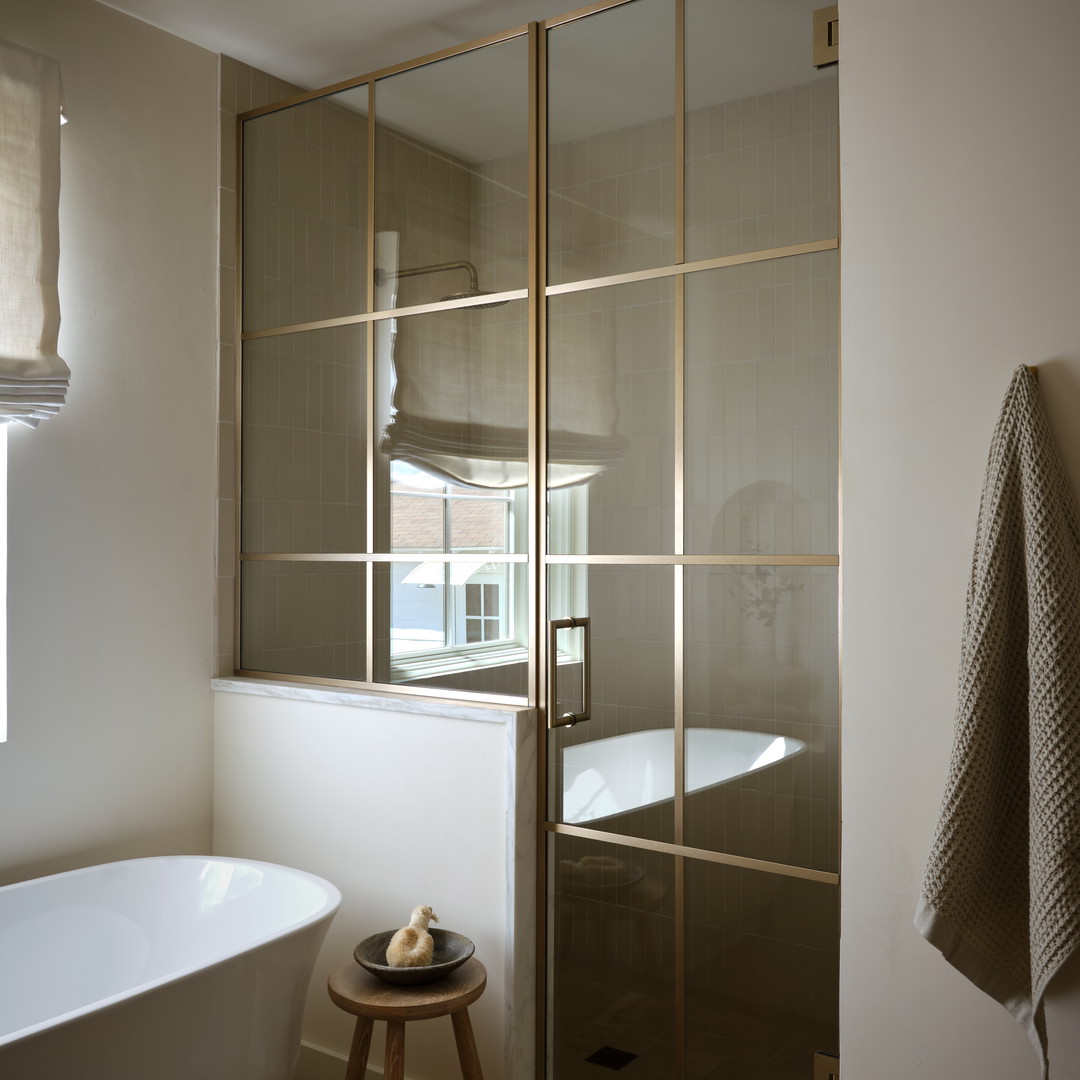 a white bath tub sitting next to a walk in shower