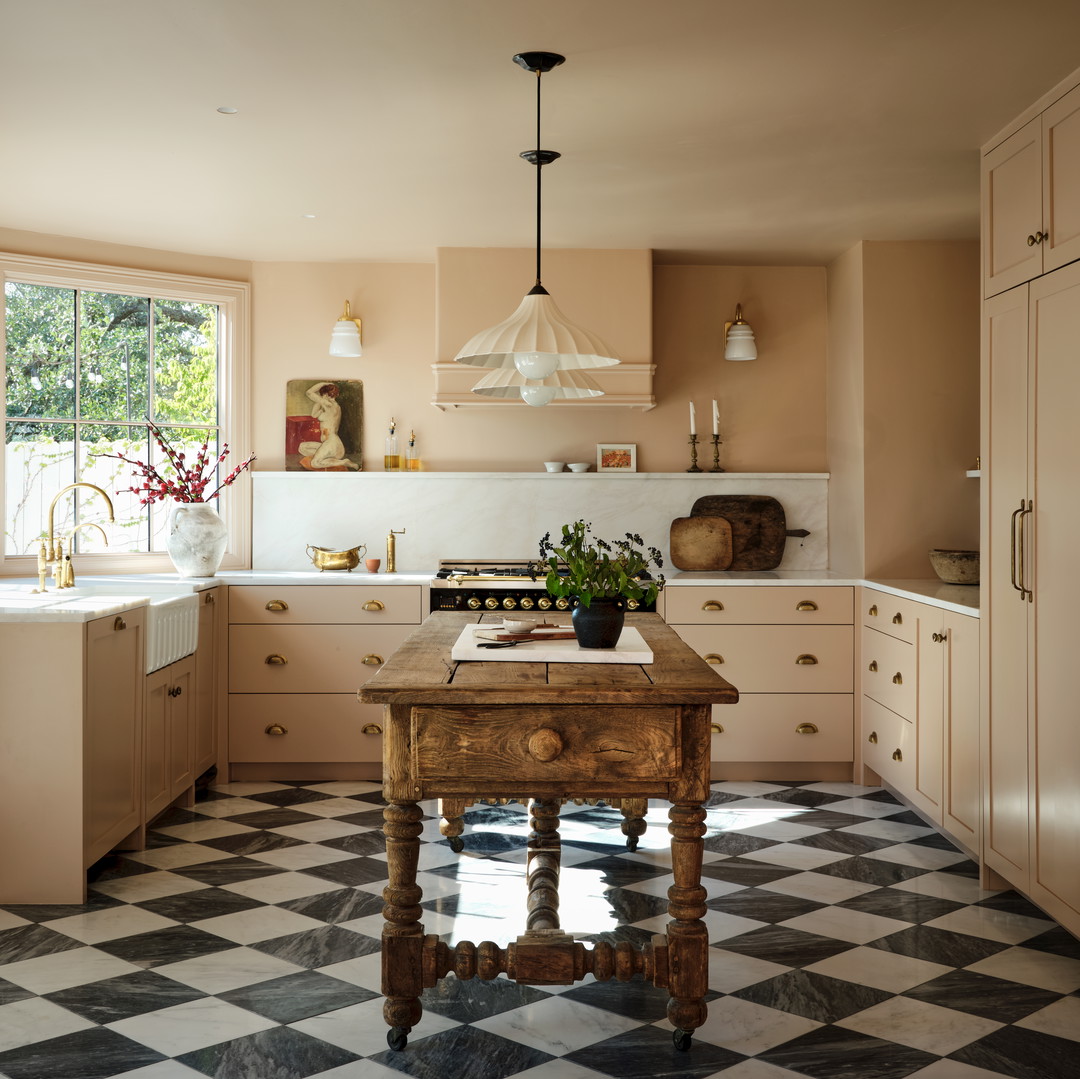 a kitchen with a checkered floor and a wooden table