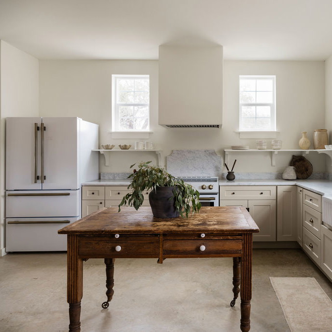 a kitchen with a table in the middle of the room