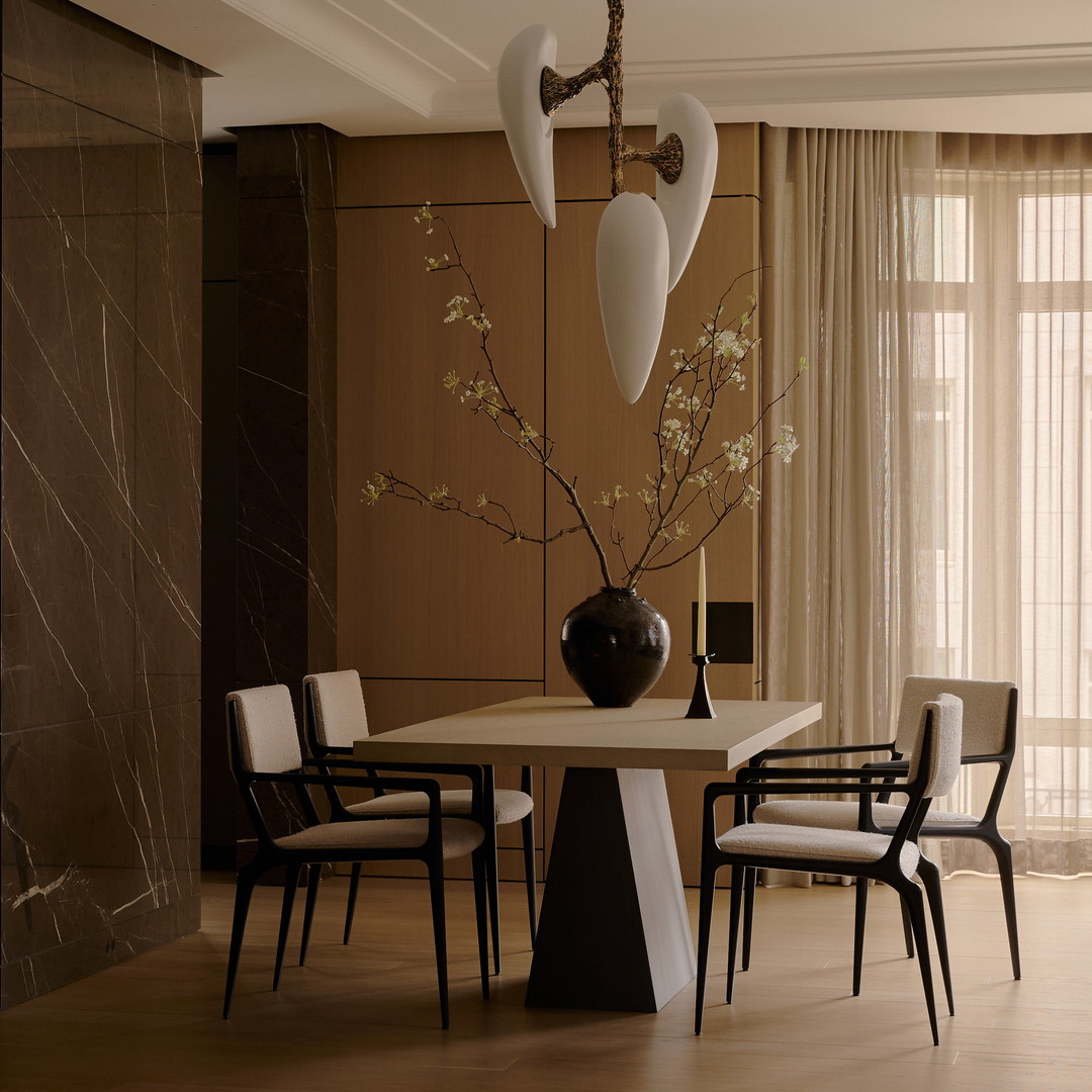 a dining room with a table and chairs