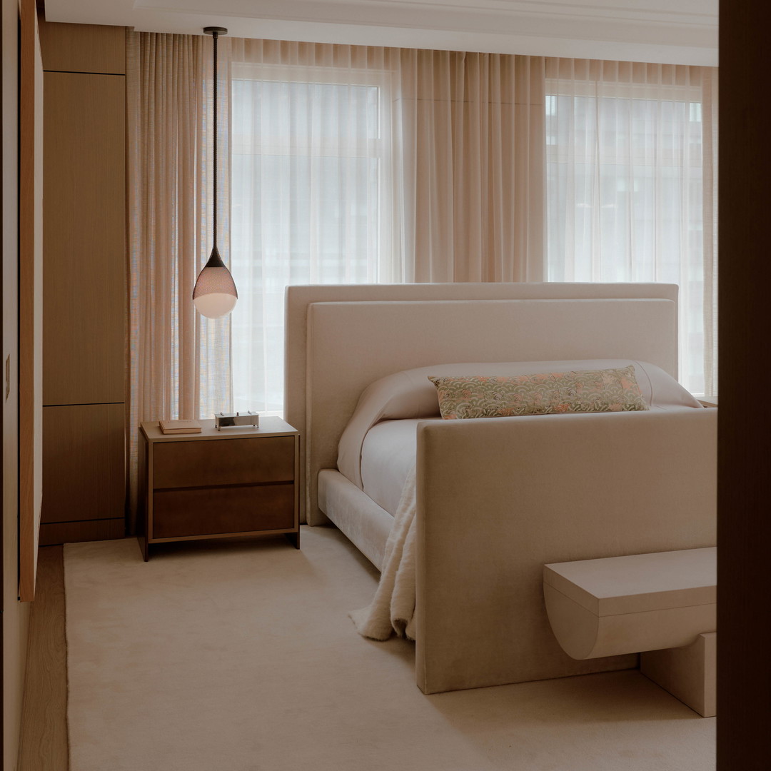a bedroom with a bed and a night stand