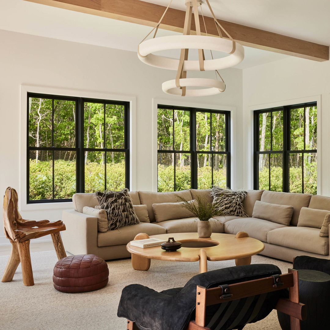 a living room filled with furniture and lots of windows