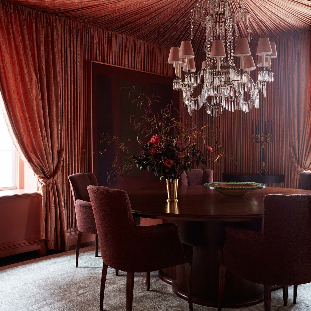 a dining room with a chandelier hanging from the ceiling