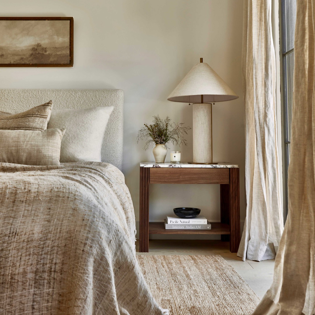 a bed sitting next to a window in a bedroom