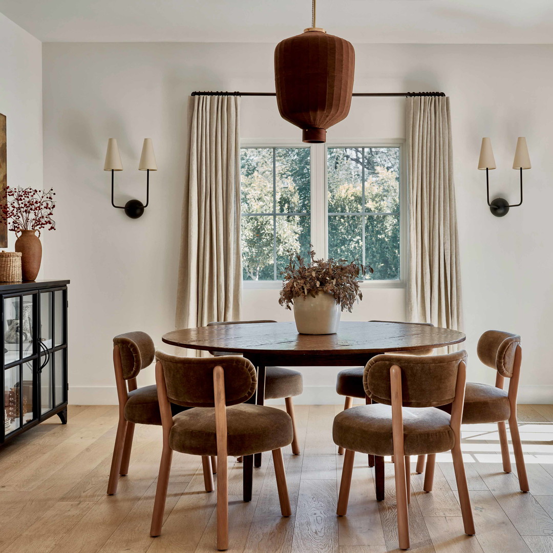 a dining room with a table and chairs