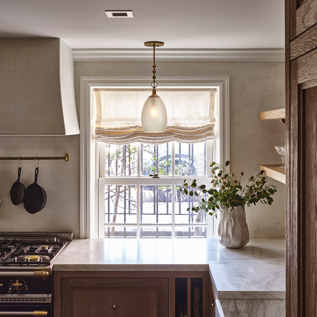 a kitchen with a stove top oven next to a window