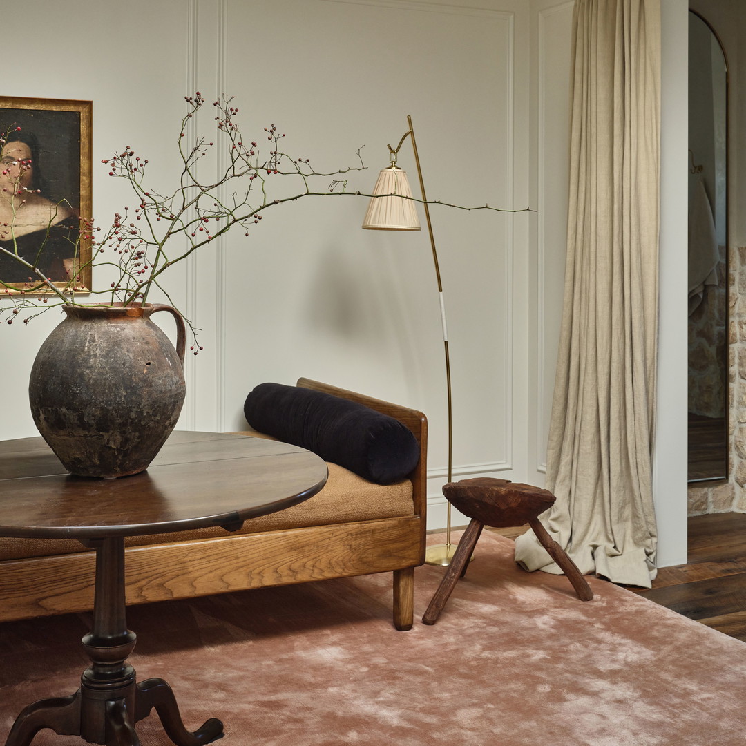 a living room with a table and a vase