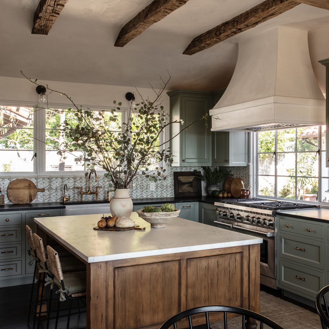 a kitchen with a center island and a stove top oven