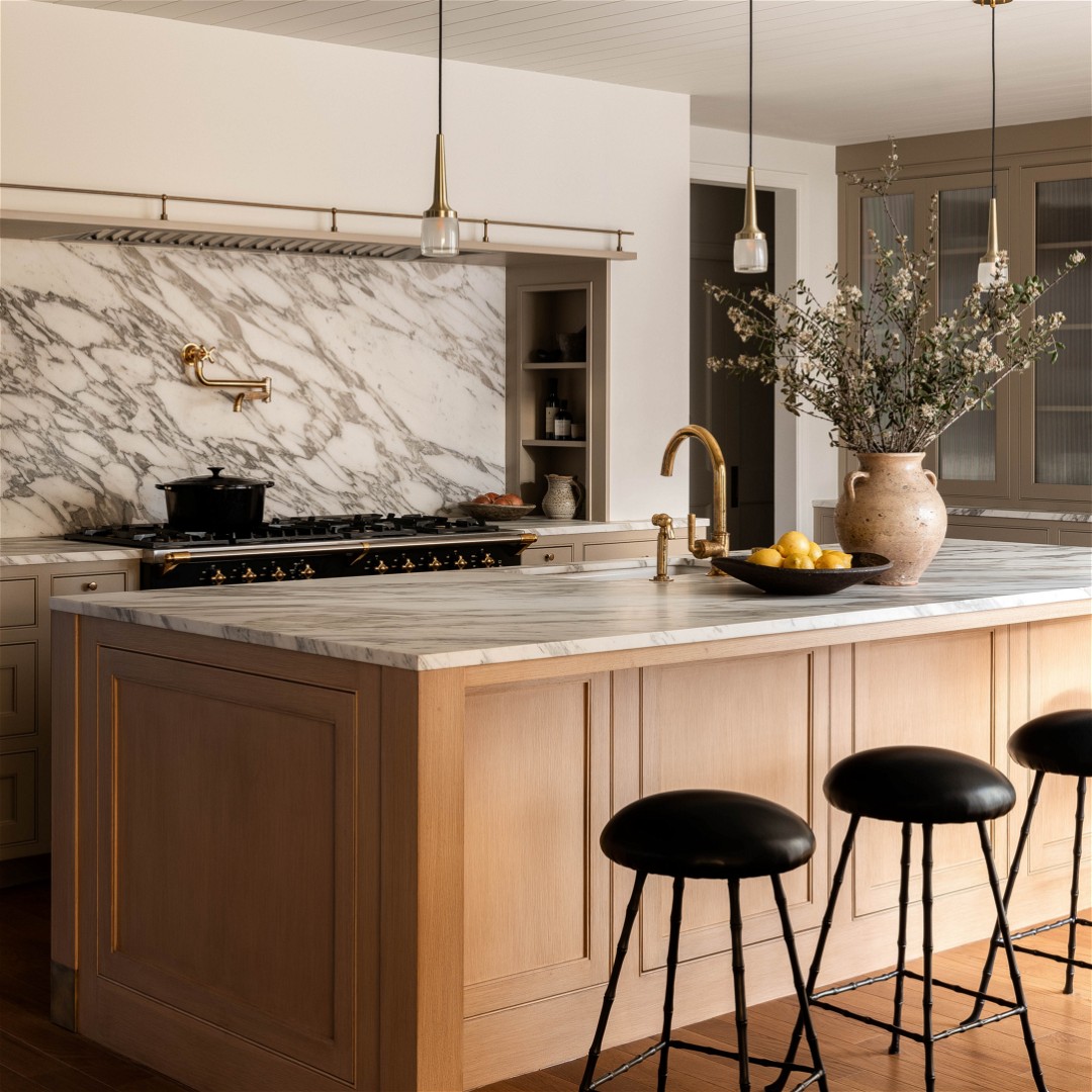 a kitchen with a marble counter top and wooden stools