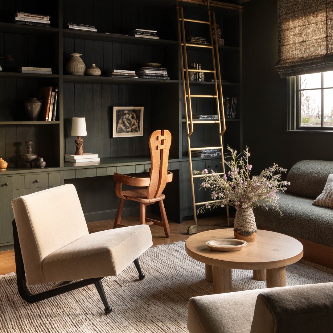 a living room filled with furniture and a ladder