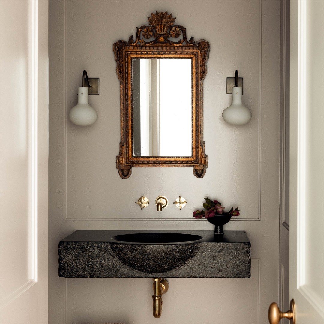 a bathroom with a sink, mirror and stool