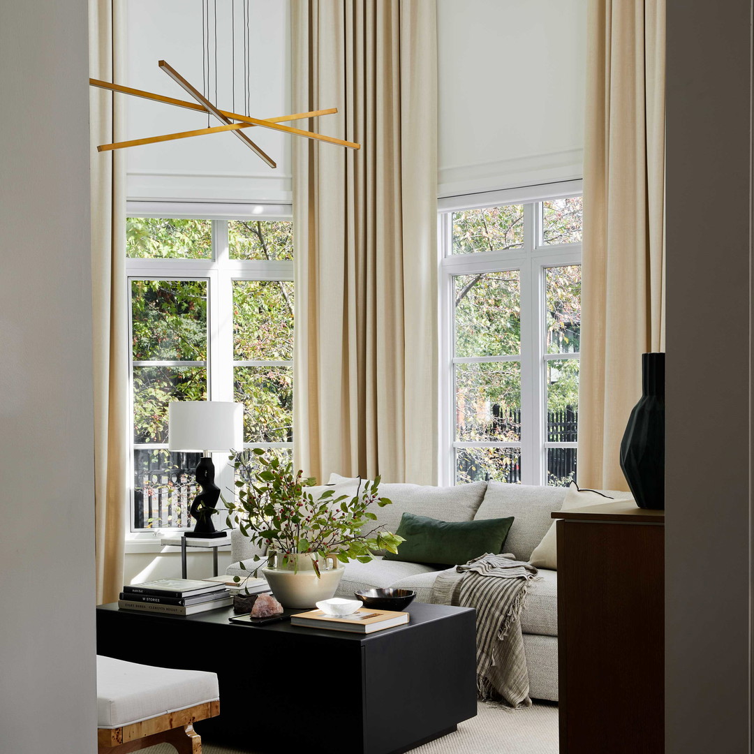 a living room filled with furniture and a large window