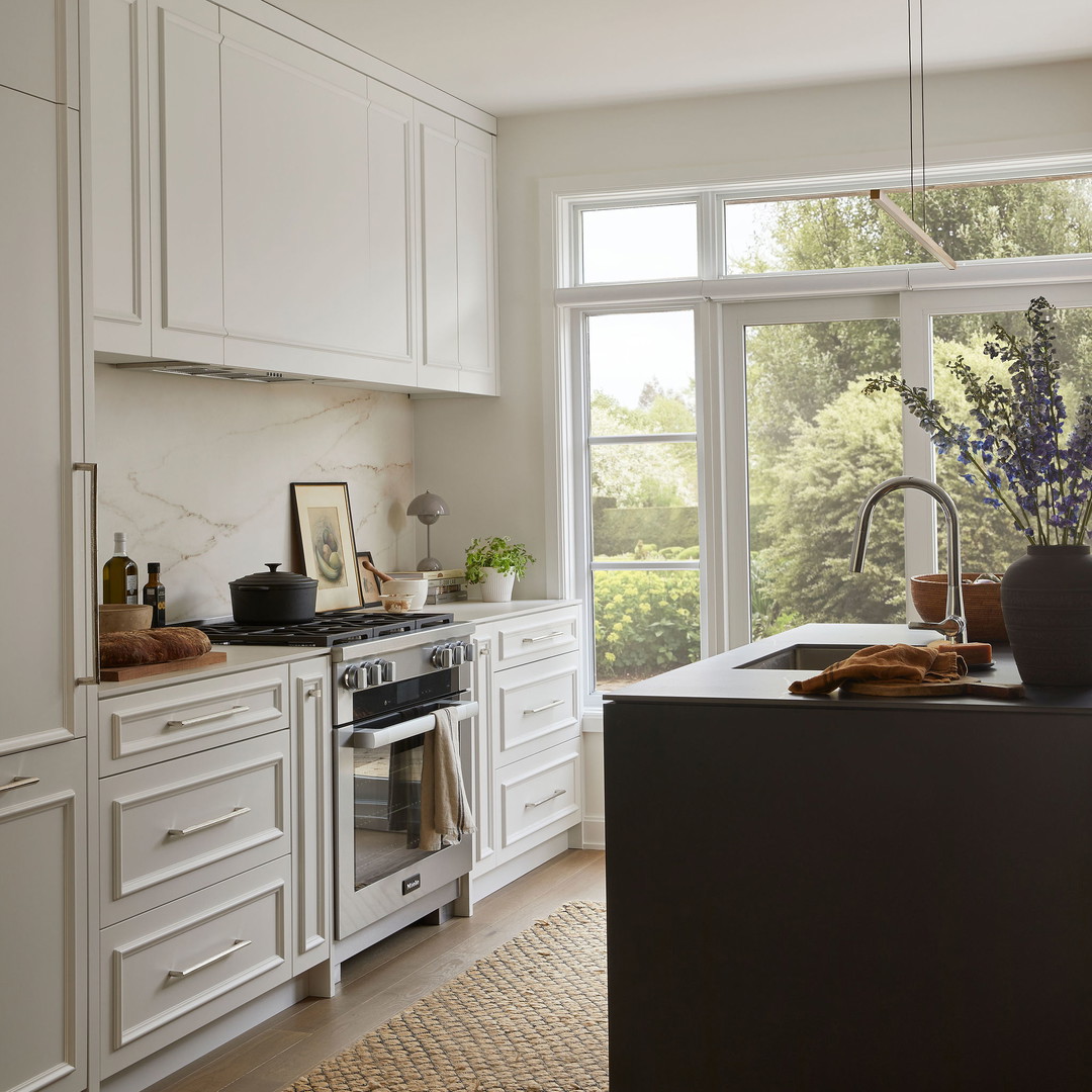 a kitchen with white cabinets and a stove