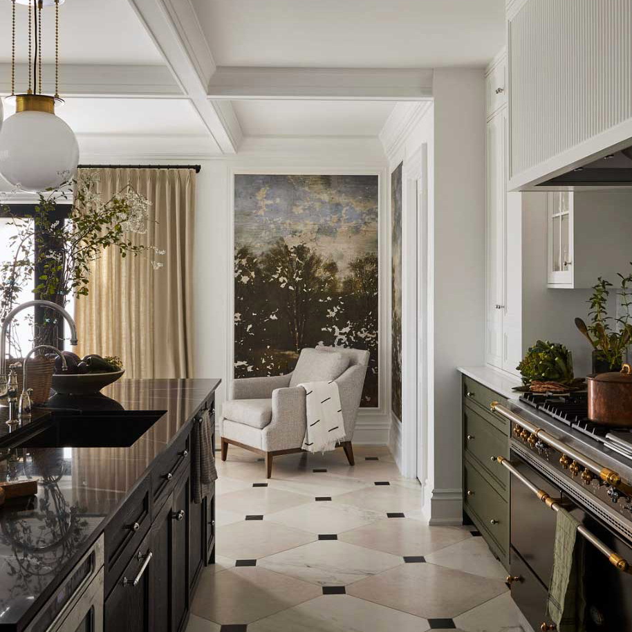 a kitchen with a stove, oven, sink, and chairs